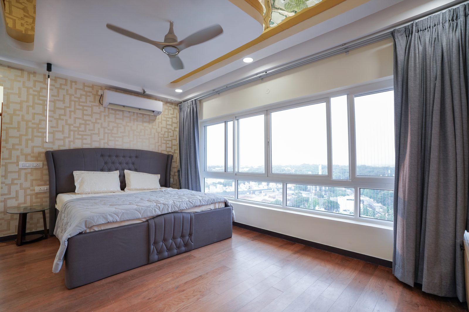 Candidscape residential bedroom interior with city-view glazing and fitted wardrobe