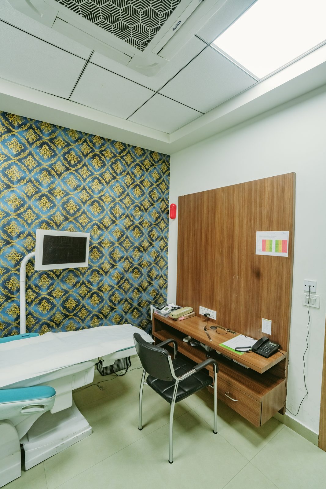 Examination room with couch and patterned wall