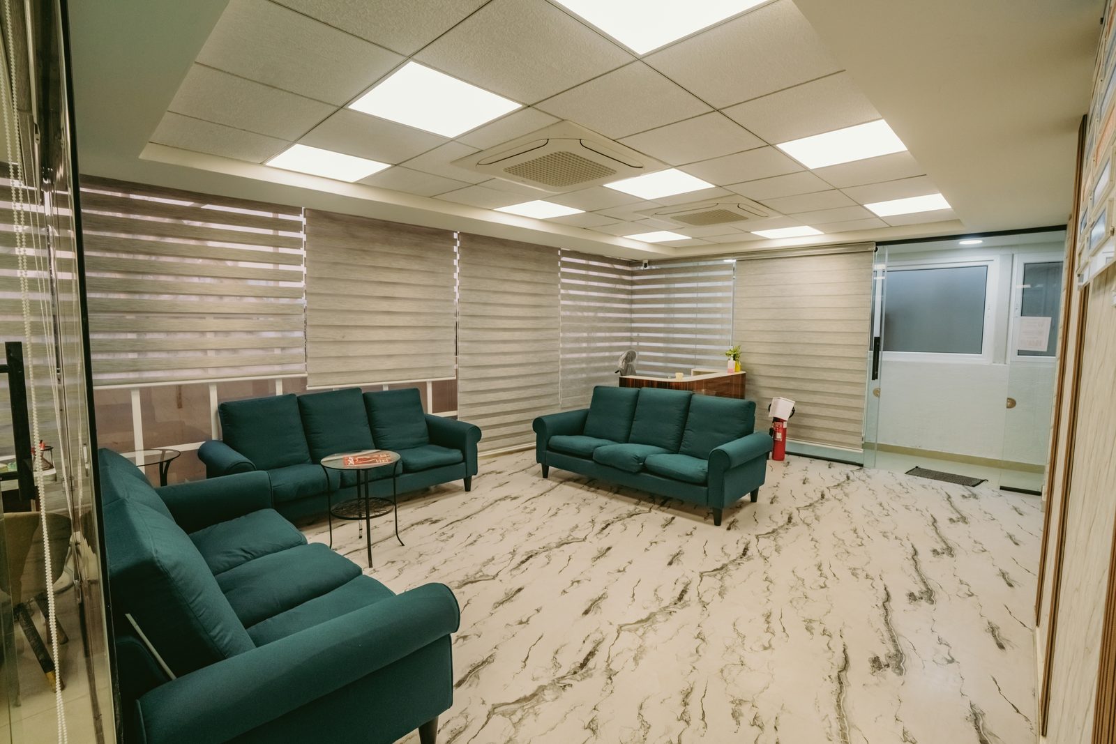 Patient lounge with teal sofa seating