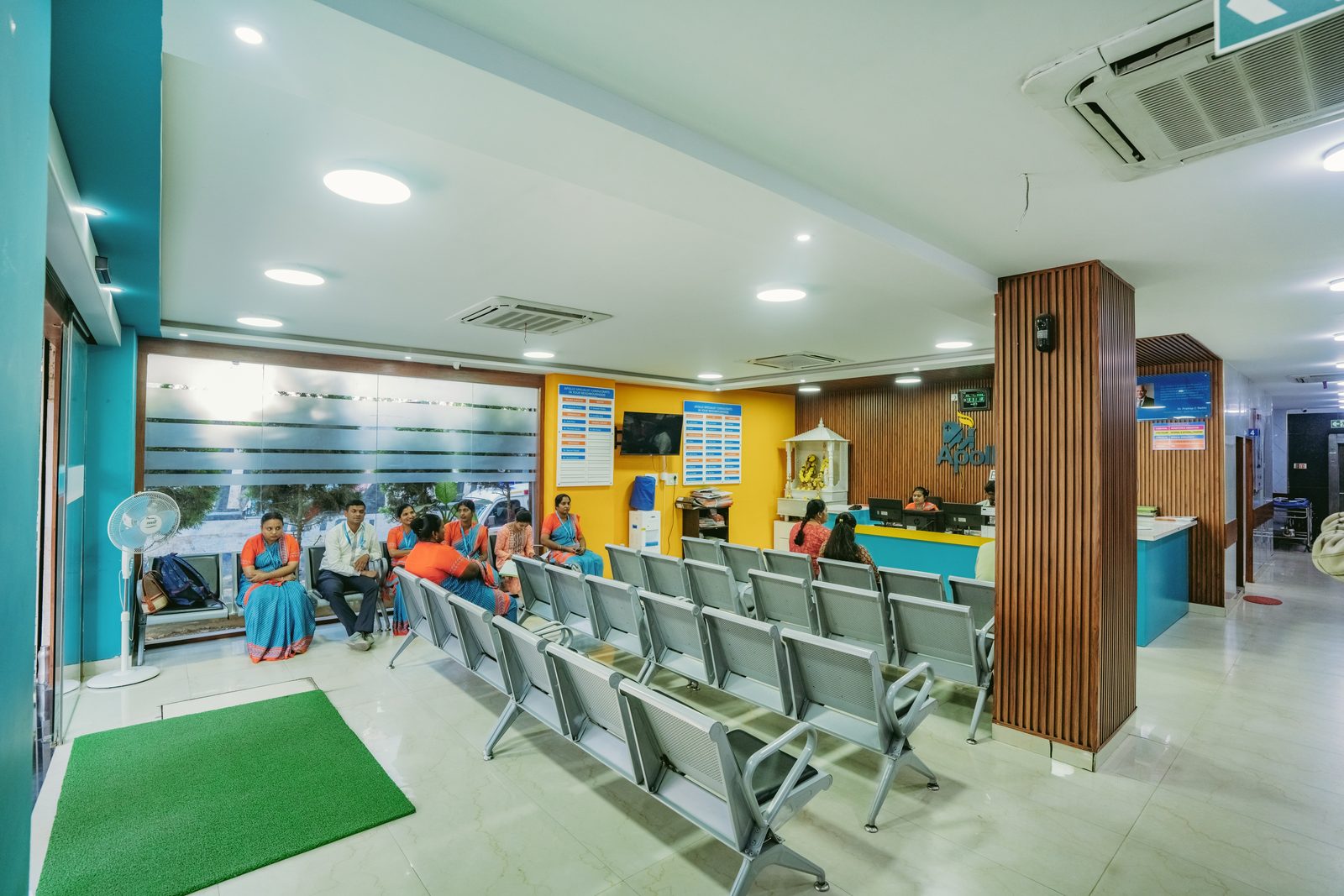 Waiting area with teal and yellow accents and wood slats