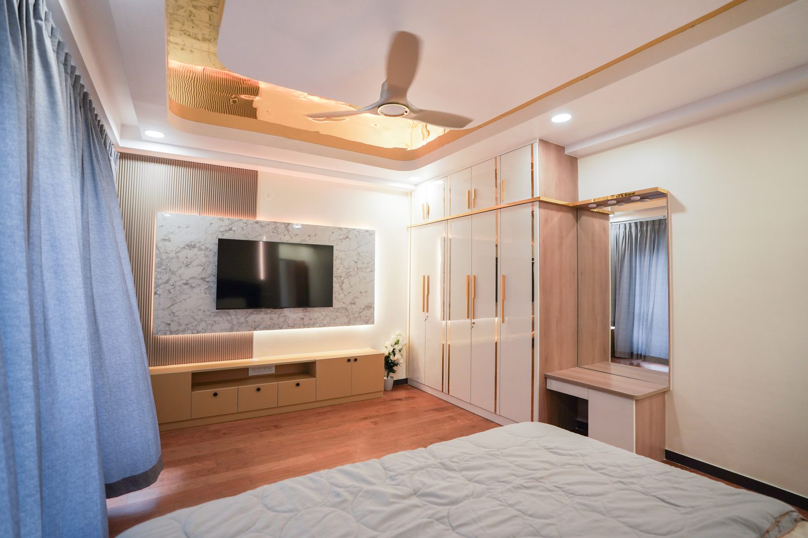 Bedroom with media wall and fitted wardrobe